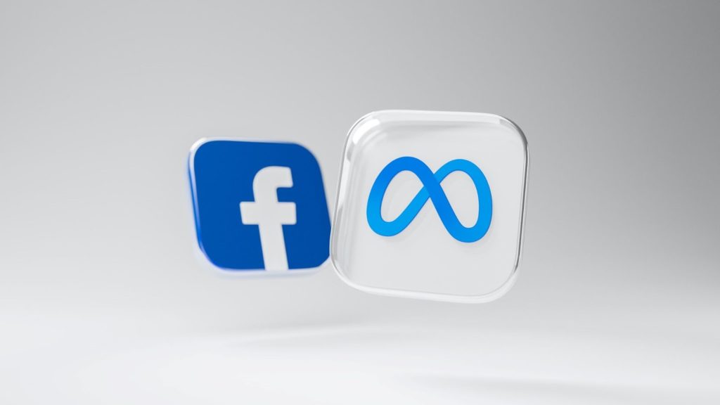 Imagen de los logos de meta y facebook sobre fondo gris.